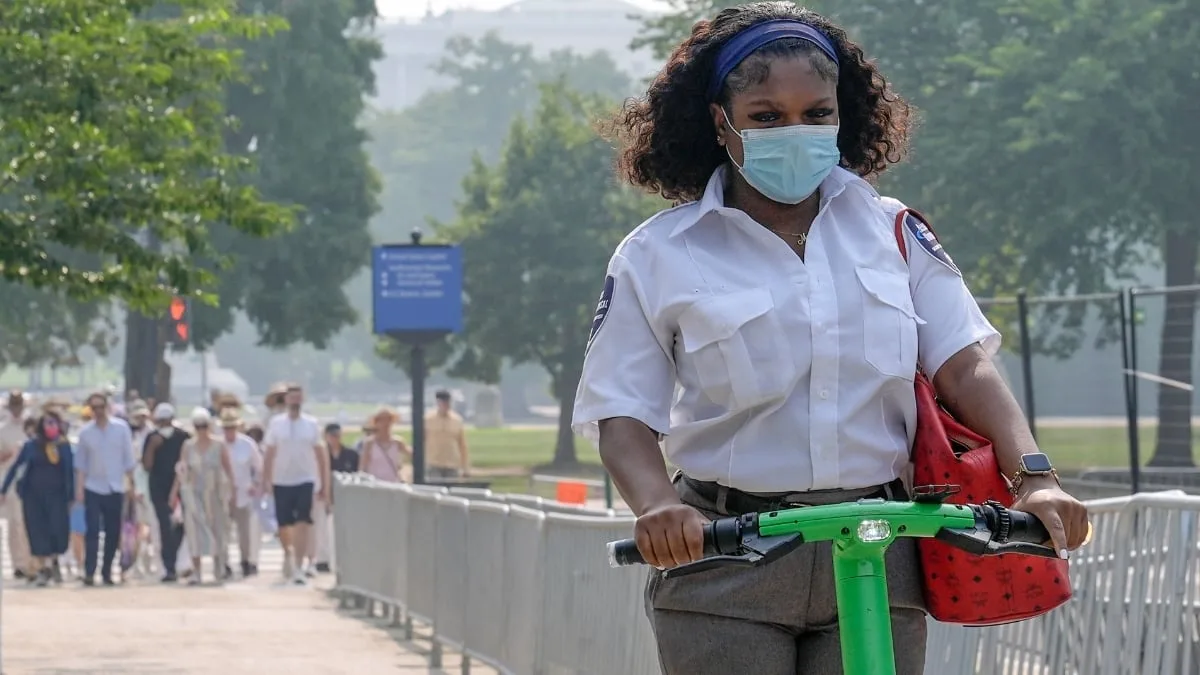 A commuter wears a face mask as smoke from wildfires blankets the sky in Washington 1