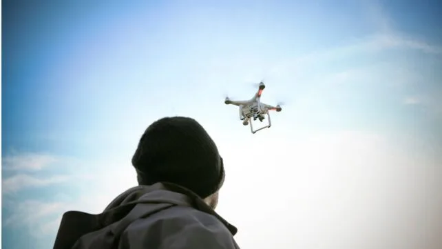 PersonLookingUpAtDroneInSky 642x361 1