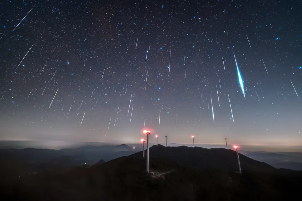 the geminid meteor shower was once again reliable in 2025 is visible as many streaks of almost vertical lifht from a mountain top l