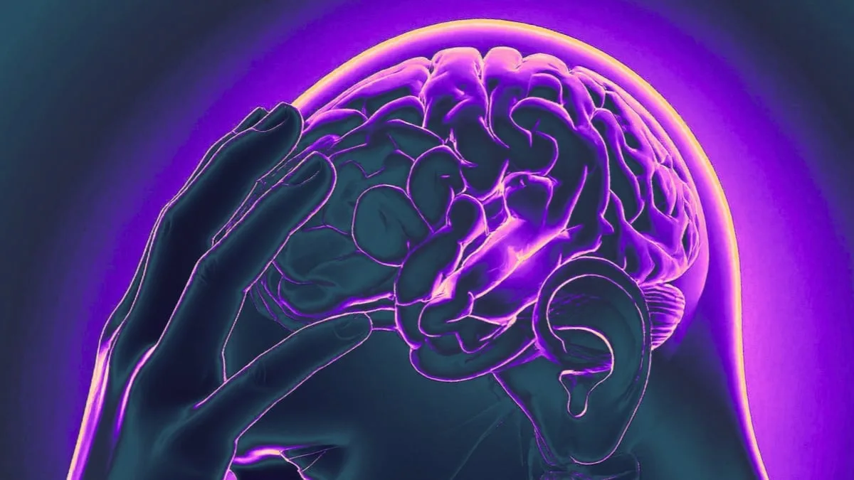 IllustrationOfHandOnBrainInPurpleAndBlue 1